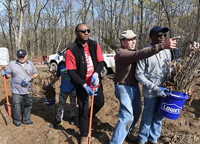 Seifert directs volunteers during a tree planting