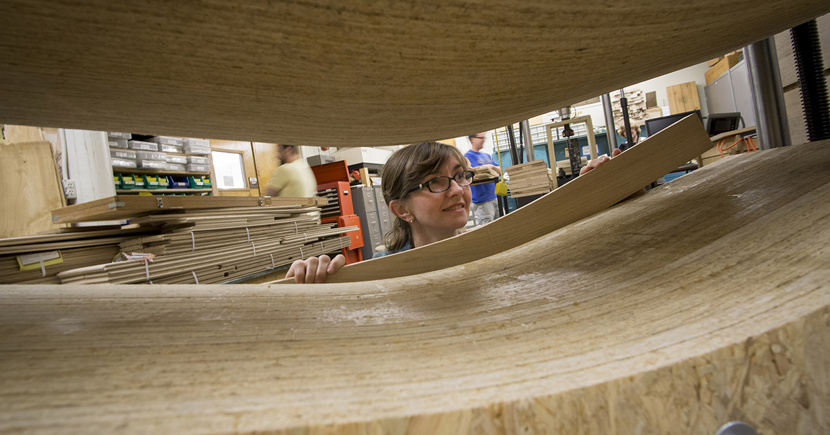 Dr. Eva Haviarova holds a piece of lumber 