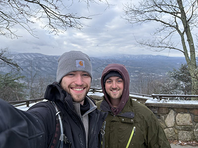 Austin Marshall and Dylan Tridle stand in front of the Smoky Mountains. 