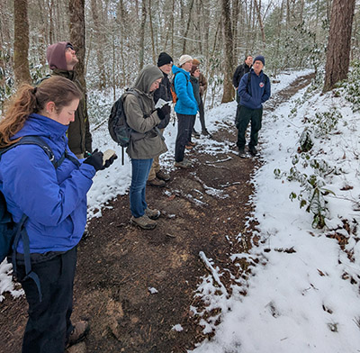 Stephanie Willsey takes notes while listening to a speaker on the Disturbance Ecology spring break trip. 