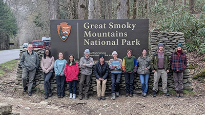 The Disturbance Ecology class stands with the Great Smoky Mountain National Park sign. 