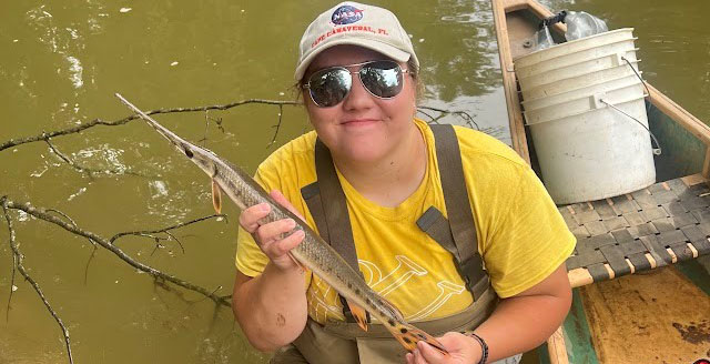Kirsten Adams with a fish she caught while performing fish community sampling during her summer internship with the Indiana Department of Environmental Management.