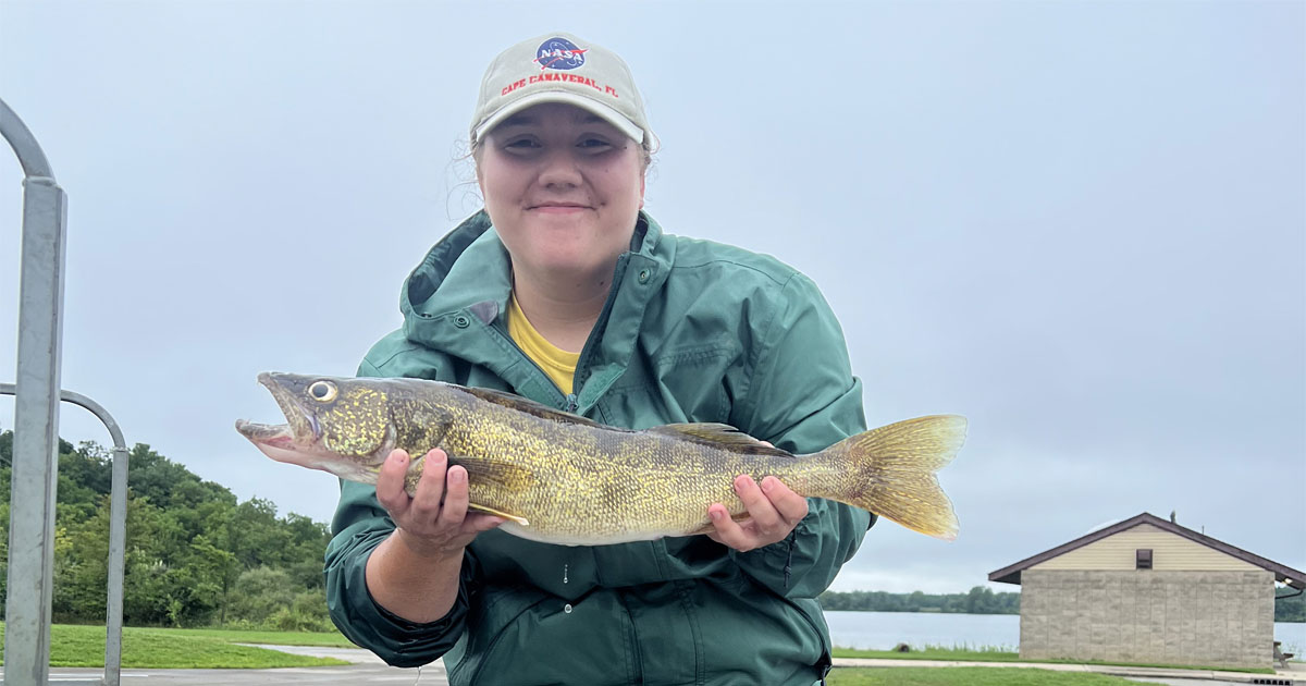 Senior aquatic sciences major Kirsten Adams pictured with fish she caught during her internship with the Indiana Department of Environmental Management.