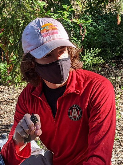 Student holding bird on class trip