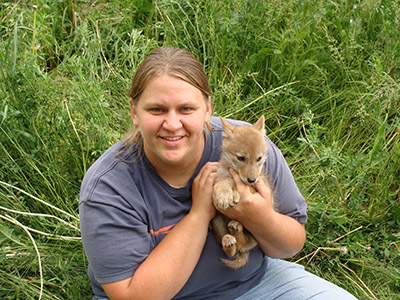 Geriann Albers holds a coyote pup in 2009.