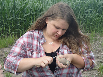 Geriann Albers banding a dove in 2014