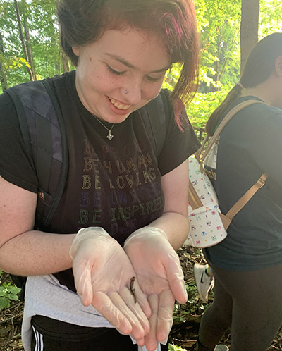 Alex Early holds a salamander