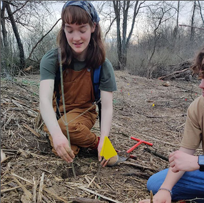 Allie Johnson plants a tree