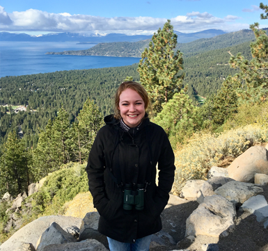 Amanda Heltzel standing outside on rocks in the forest