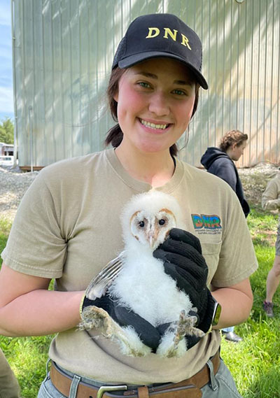 Autumn Hall holding a baby Barn Owl from when she observed a barn owl banding in Southern Indiana. 