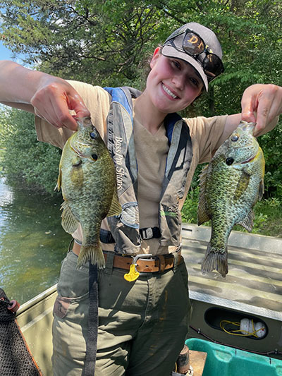 Autumn Hall holding two large Redear Sunfish that were caught in Michigan style trap nets when she did a full survey at Grouse Ridge Lake. 