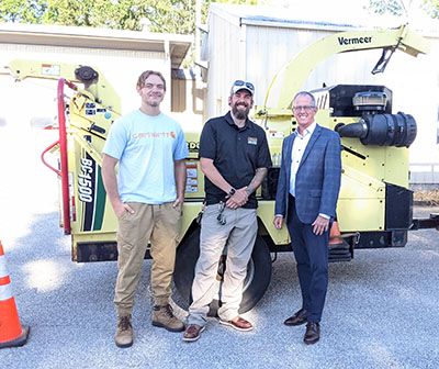 Forest Summerfield, Ben McCallister and Scott Jamieson with the chipper Bartlett Tree Experts donated to Purdue FNR