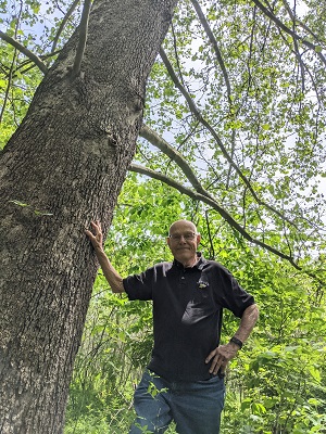 Beineke next to a sycamore