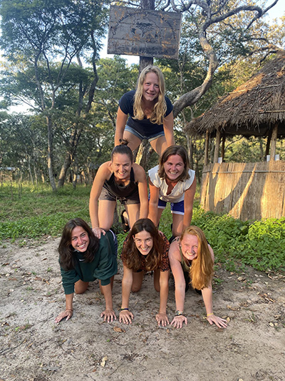 A photo of Ruth (second row, left) and other foreign students/researchers doing work at the Greater Mahale Ecosystem Research Conservation camp in the Issa Valley