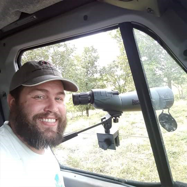 Brandon Quinby in a car with equipment