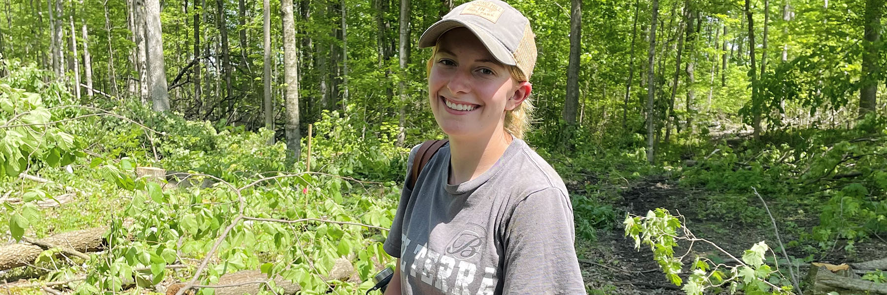 Senior wildlife major Summer Brown planting trees during her summer job with Purdue FNR.