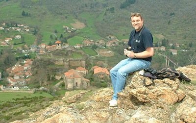 Ted Cable sits on a hillside overlooking a European town