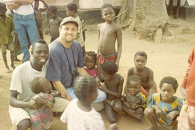 Ted Cable with children in Africa