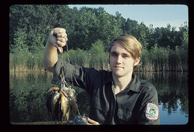 Ted Cable holds a bunch of fish as an employee at Cook County Forest Preserve.