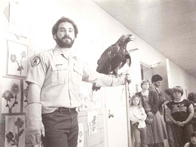 Dave Case presents an eagle in a classroom for the Kansas Fish and Game Commission in 1985.