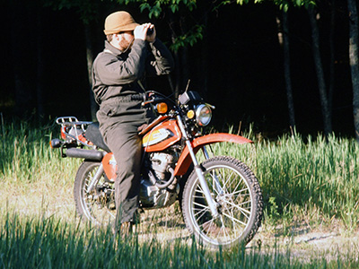 Dave Case on North Manitou Island doing deer research on a motorcycle in 1980