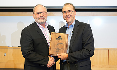 Dave Case receives the 2023 FNR Lifetime Achievement Award from Phil Seng.