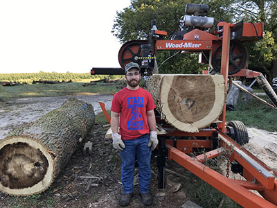Charlie Warner, 2021 forestry alumnus, helping with log cutting at Cassens Trees