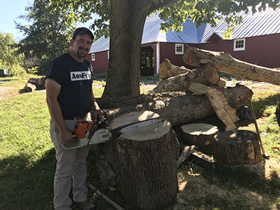 Daniel Warner, 2011 wood products manufacturing technology alumnus, splitting a burl at Cassens Tree farm