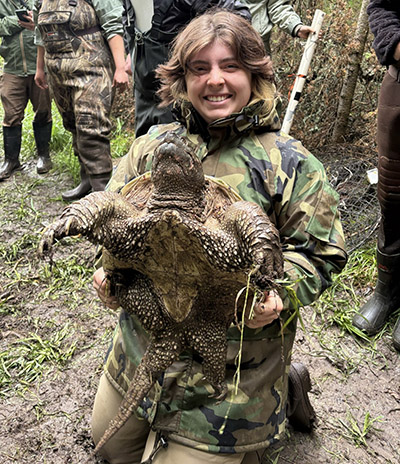 Max Clark holds a large snapping turtle