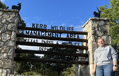 Julia Buchanan-Schwanke with the Kerr Management Area sign
