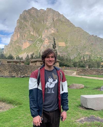 Jack Dempsey in front of a sun gate in Ollantaytambo, study abroad.