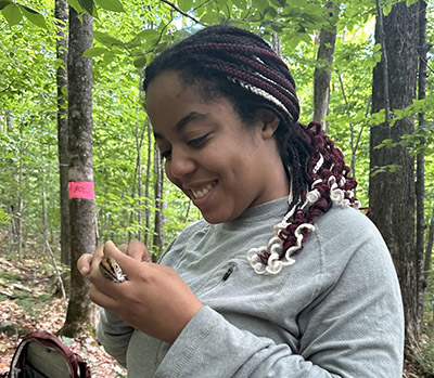 Gabby Dennis holds a bird during a banding session.