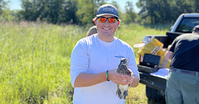 Tim Radtke holds a wood duck at LaSalle Fish and Wildlife Area