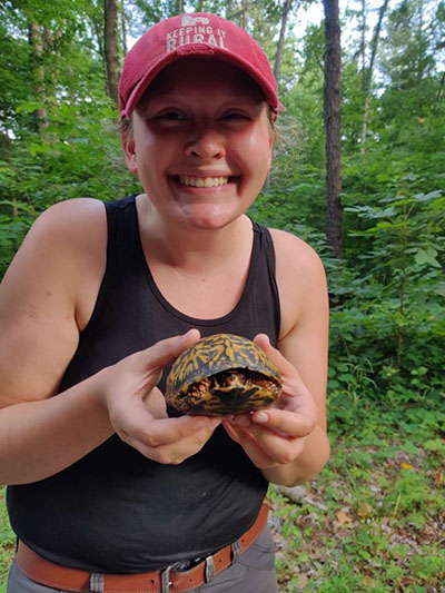 Alex Dudley with a turtle