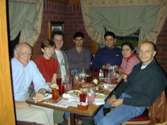 Dr. Carl Eckelman at dinner with some of his students