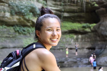 Emilie Washer posing by a creek