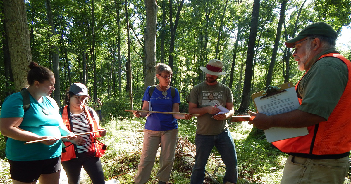 Lenny Farlee shows teachers how to use a Biltmore stick at the Natural Resources Teachers Academy. 