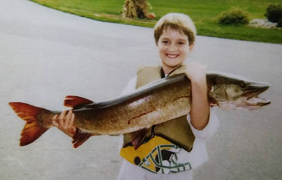 Zach Feiner holds a large fish as a child