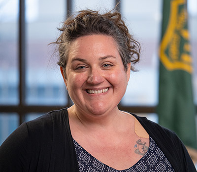 Kristen Floress stands in front of the landscape at Yellowstone National Park. 