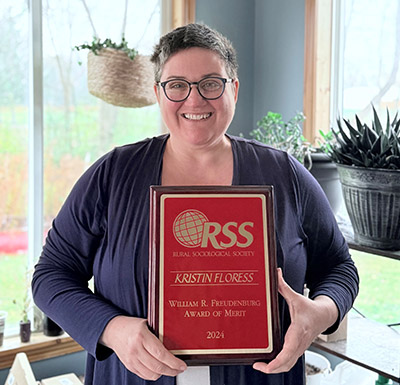 Kristin Floress with her William R. Freudenburg Award of Merit plaque