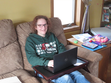 Caroly Foley at home on computer, Unsung Hero Award.