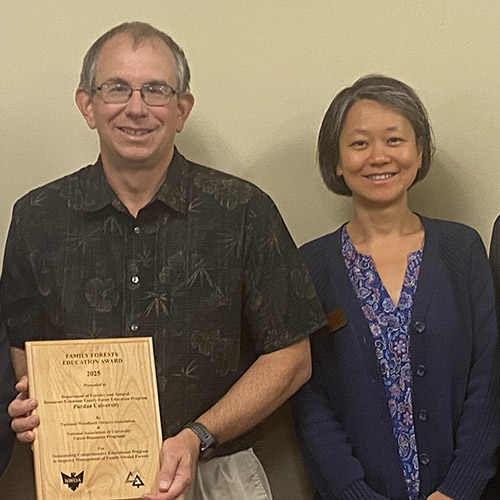 Drs. Mike Saunders and Zhao Ma pose with the Family Forests Comprehensive Education Program Award presented by National Woodland Owners Association (NWOA) and National Association of University Forest Resources Programs (NAUFRP). 