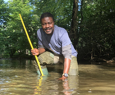 Frimpong in his favorite stream, Toms Creek near Blacksburg, VA, where he studies the reproductive behaviors of Bluehead Chub (Nocomis leptocephalus).