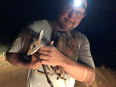 Dr. Jacob Goheen holds a one-day old dikdik