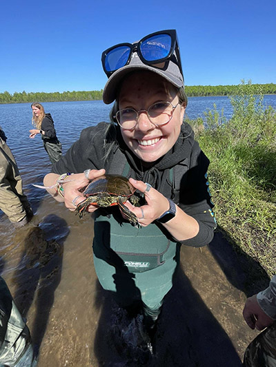 Grace Brown holds a turtle