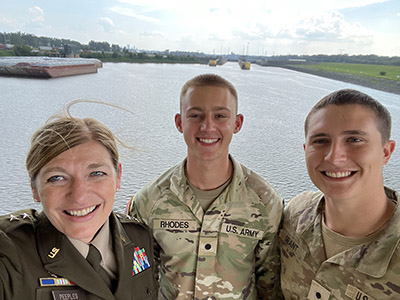 Austin Grant with Major General Kimberly Peeples and another colleague