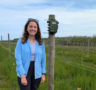 Sarah Grimes deploys an automated recording unit (ARU) at a vineyard in northern Michigan.