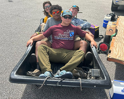 Noah Haas and his crew sitting in the Barge for a photo on their lunch break