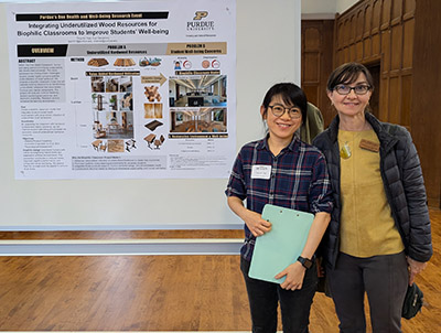 Dr. Eva Haviarova and Ting-Ho Tsai stand next to a research poster about their biophilia work.