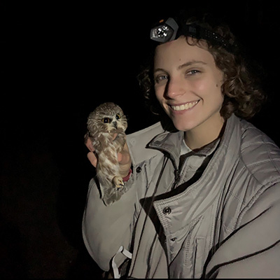 Undergraduate researcher Helen Nesius poses with a northern saw-whet owl banded as part of a research project at Purdue.